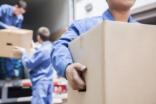 Experienced movers handling office equipment with care