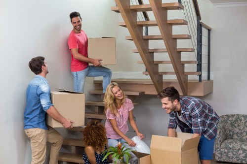 Professional movers loading a van with household items